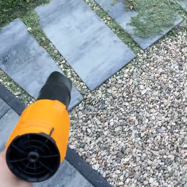 SuperLeafBlower clearing grass clippings off a stepping stone walkway