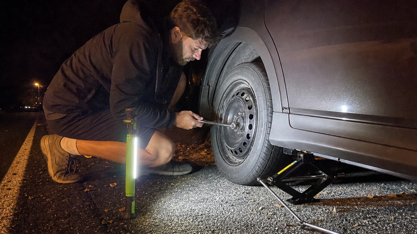 SuperTorch lighting up a roadside tire change at night for a real customer